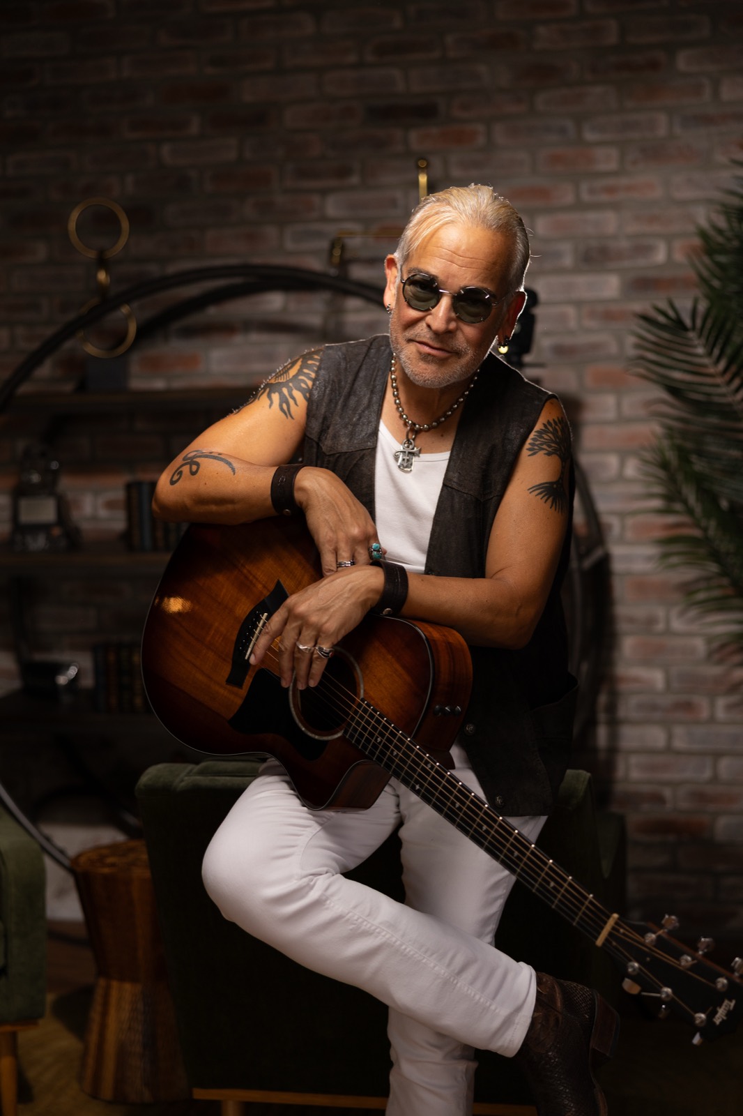 Rik Avalos with an acoustic guitar, studio portrait